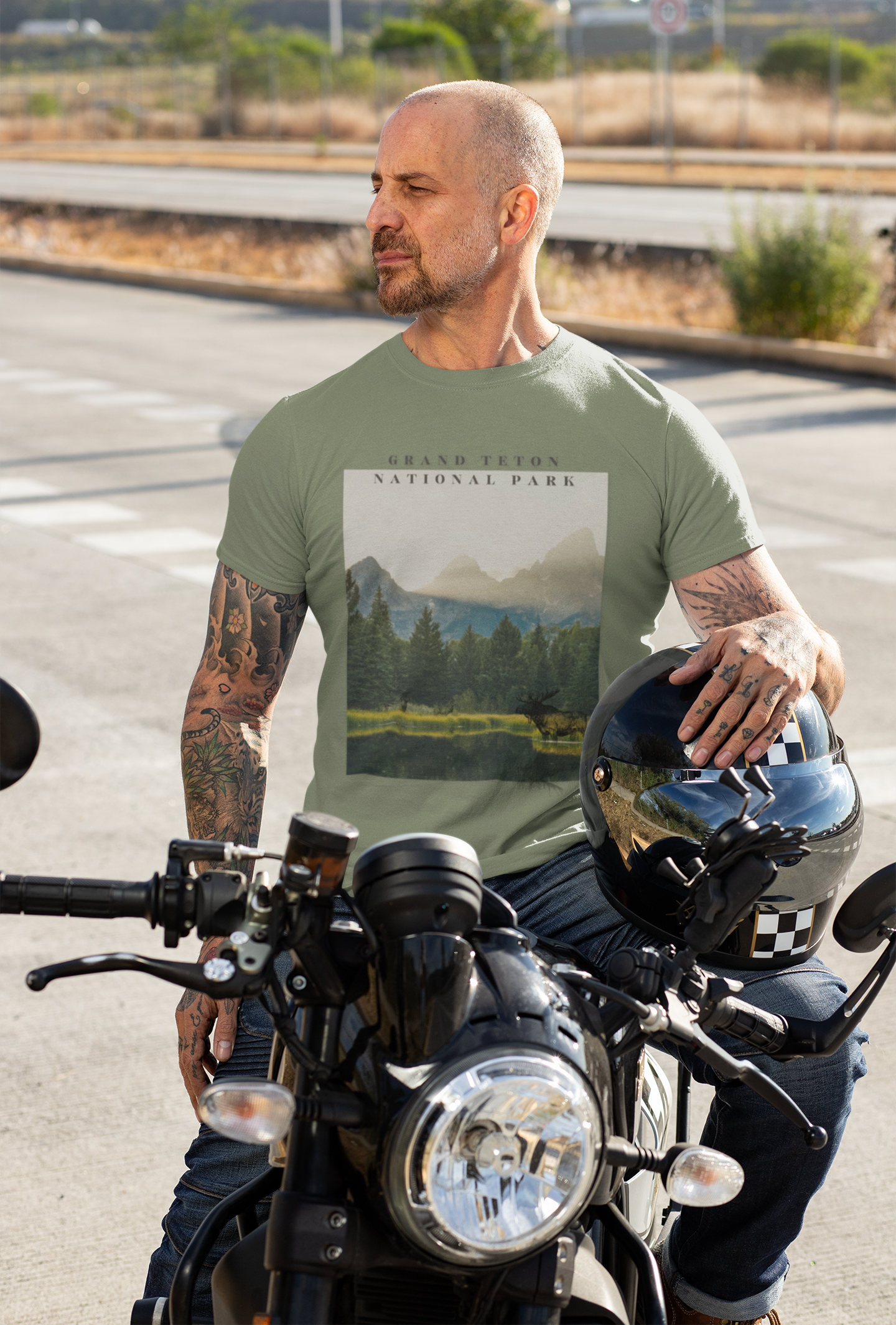 Man on a motorcycle wearing a t-shirt with a national park graphic