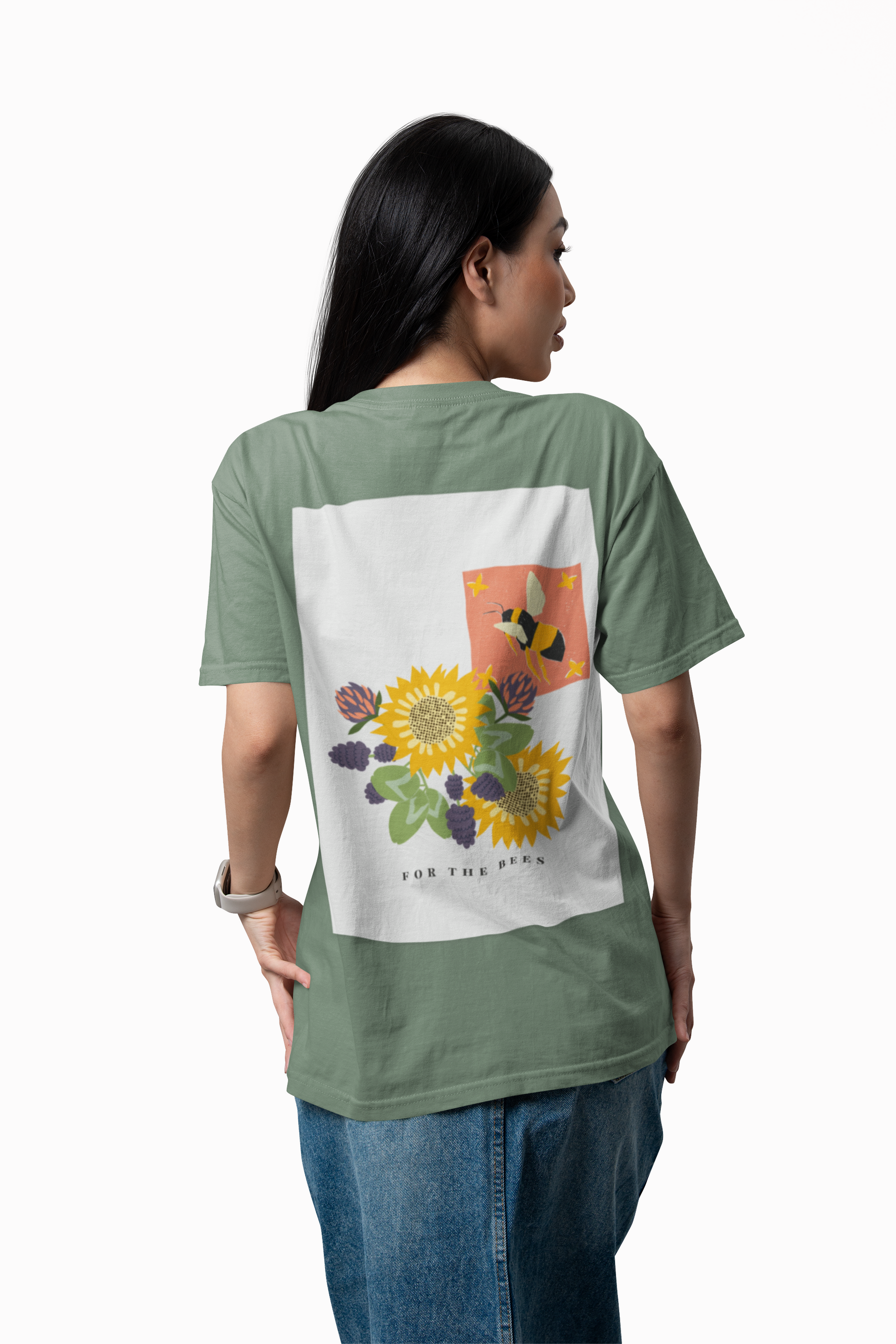Person wearing a green t-shirt with a floral design on the back, standing against a white background.