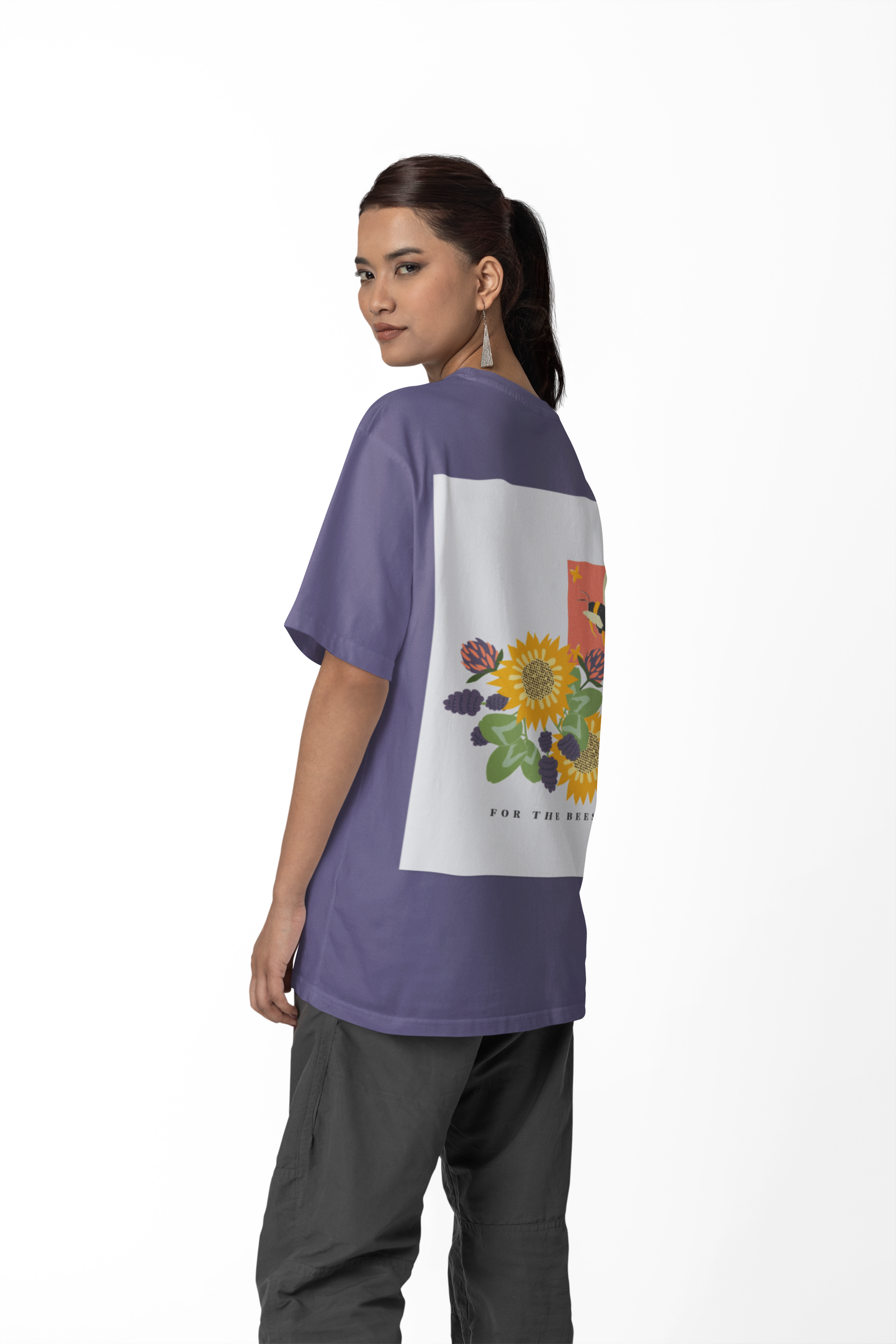 Person wearing a purple t-shirt with a colorful floral design on a white background