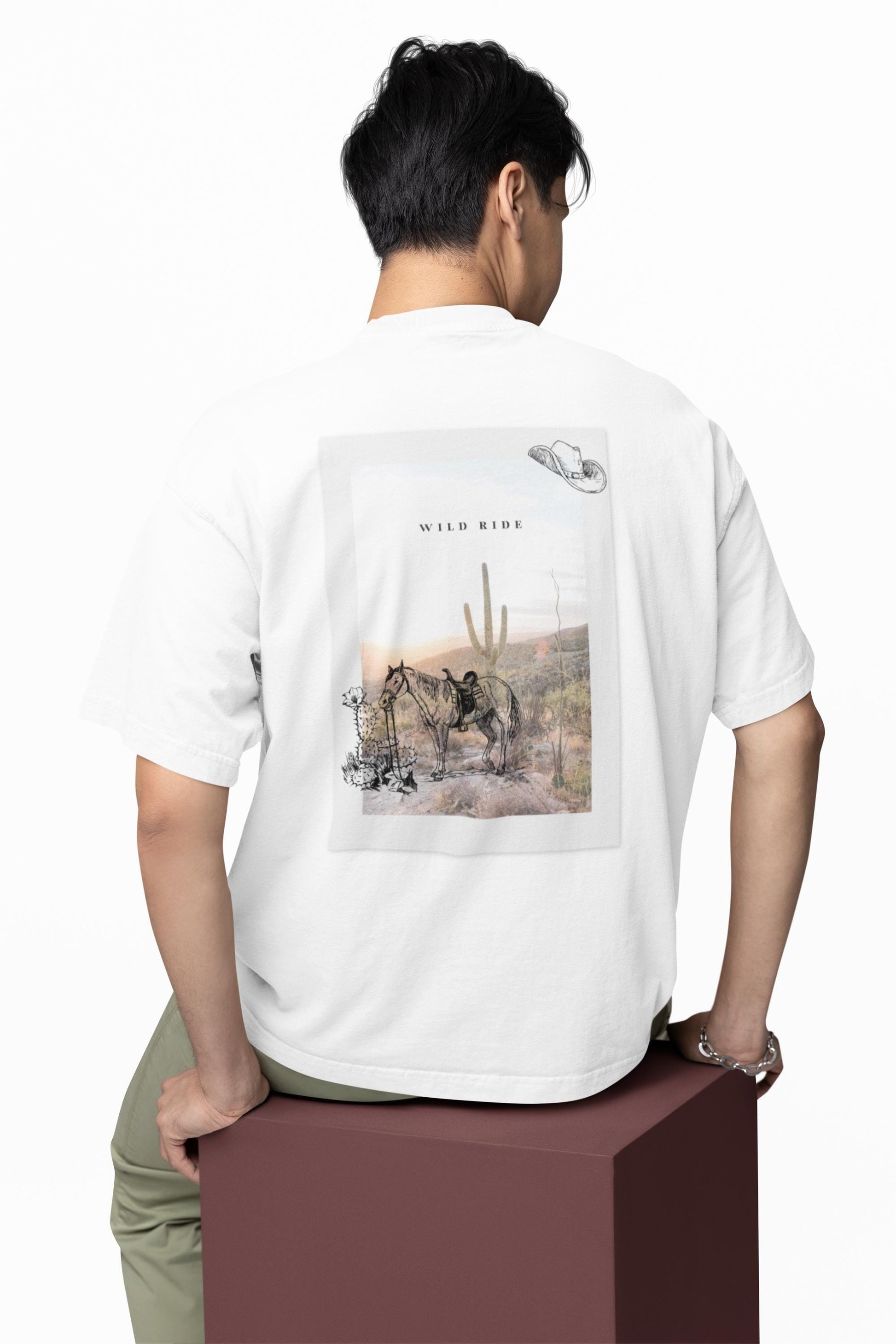 Person wearing a white t-shirt with a graphic design on the back, standing on a white background.