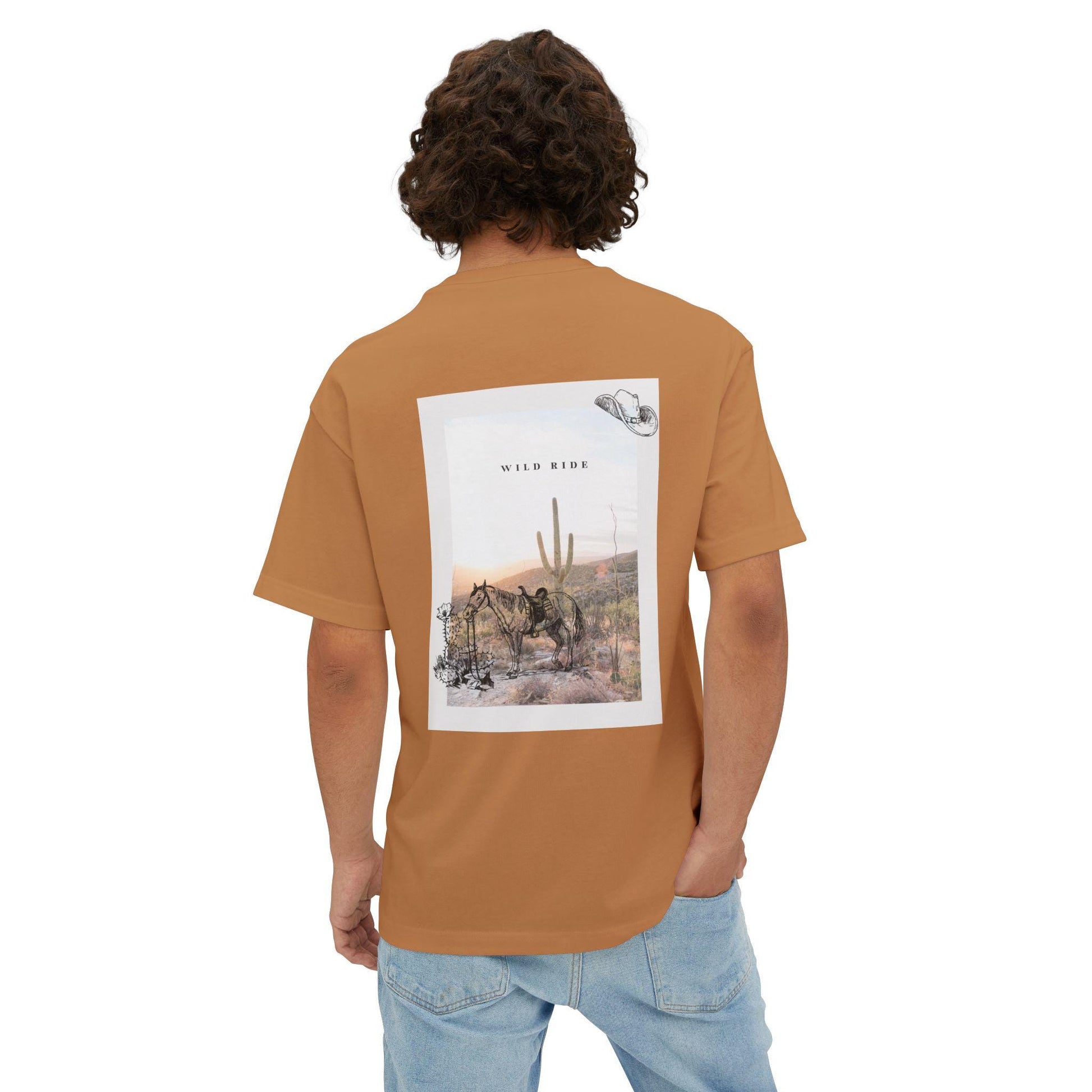 Person wearing a brown t-shirt with a graphic of a desert scene and text on the back.